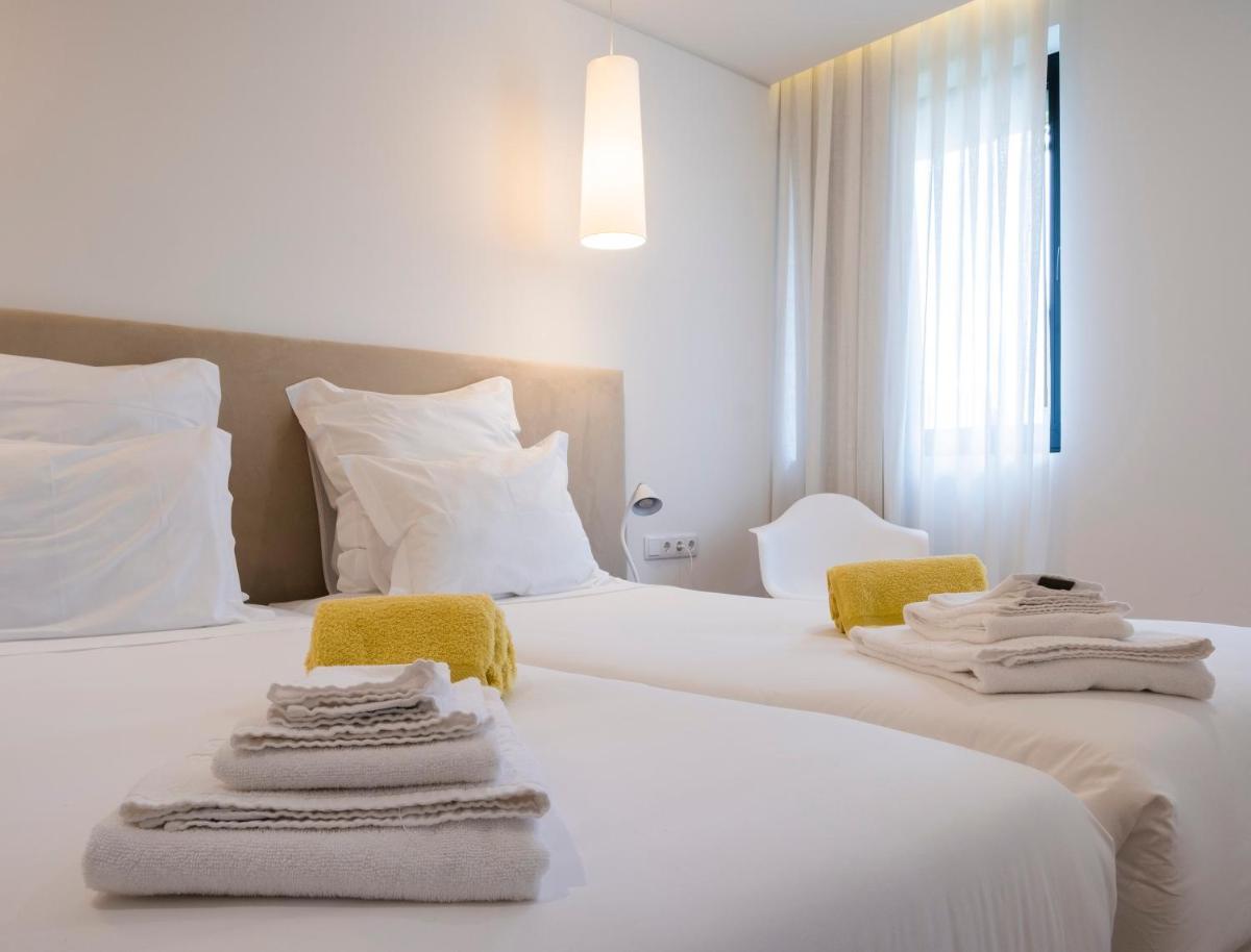 Uma cama ou camas num quarto em Aqua - Pópulo Eco Village