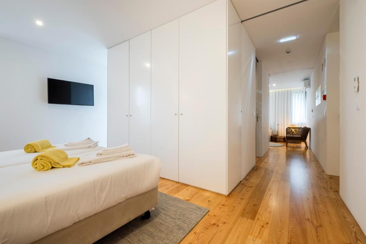 Uma cama ou camas num quarto em Aqua - Pópulo Eco Village