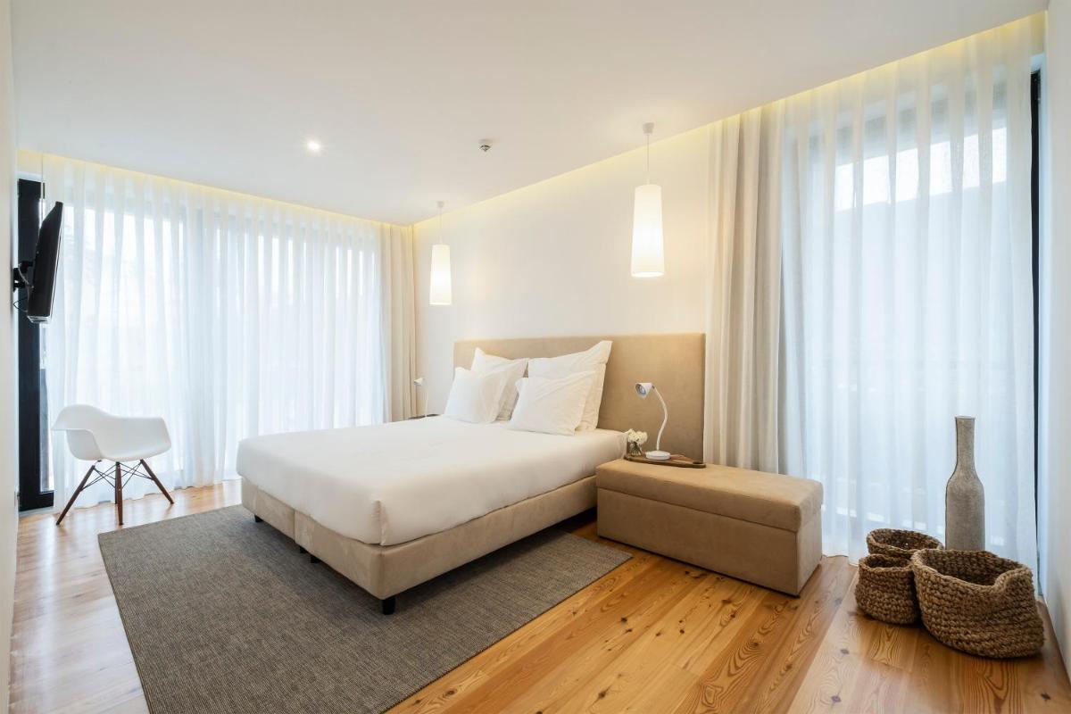 Uma cama ou camas num quarto em Aqua - Pópulo Eco Village