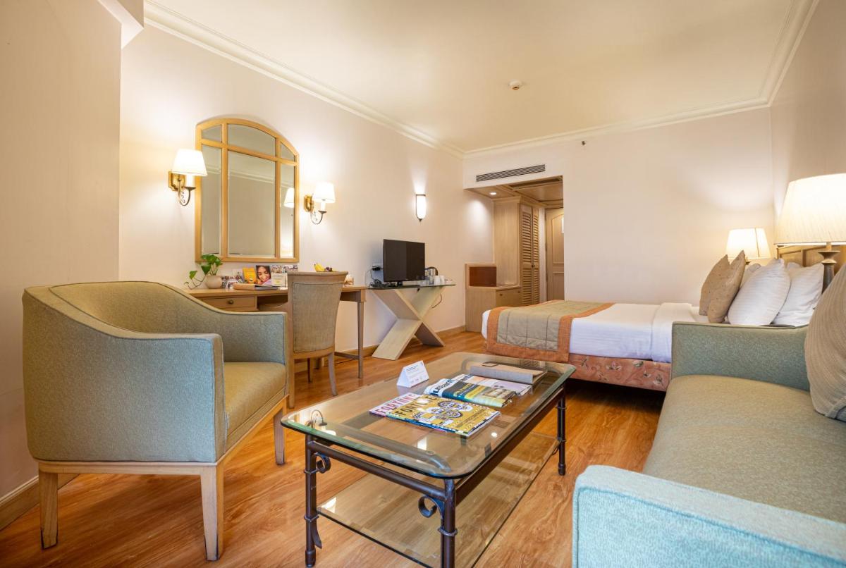 a hotel room with a bed and a table at The Orchid Hotel Mumbai Vile Parle in Mumbai