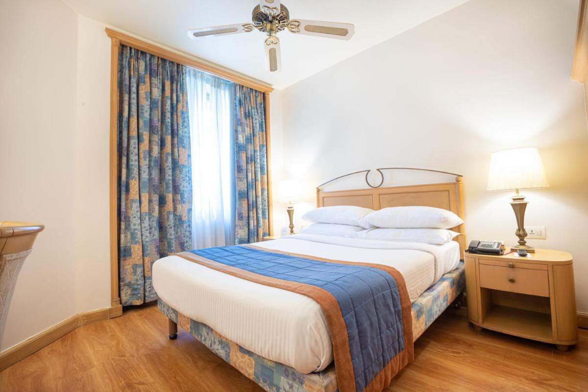 a bedroom with a large bed and a window at The Orchid Hotel Mumbai Vile Parle in Mumbai
