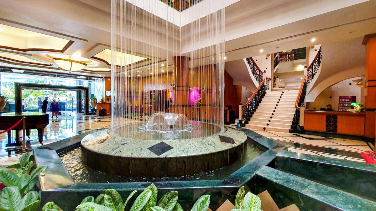 a lobby with a fountain in the middle of a building at The Orchid Hotel Mumbai Vile Parle in Mumbai