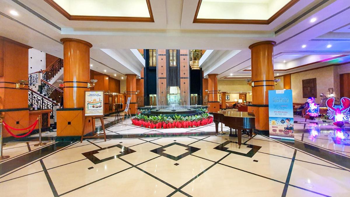 a lobby with a grand piano in a building at The Orchid Hotel Mumbai Vile Parle in Mumbai