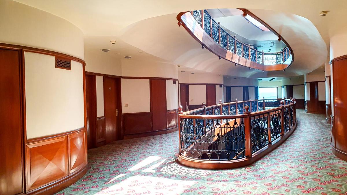 a lobby with a spiral staircase in a building at The Orchid Hotel Mumbai Vile Parle in Mumbai