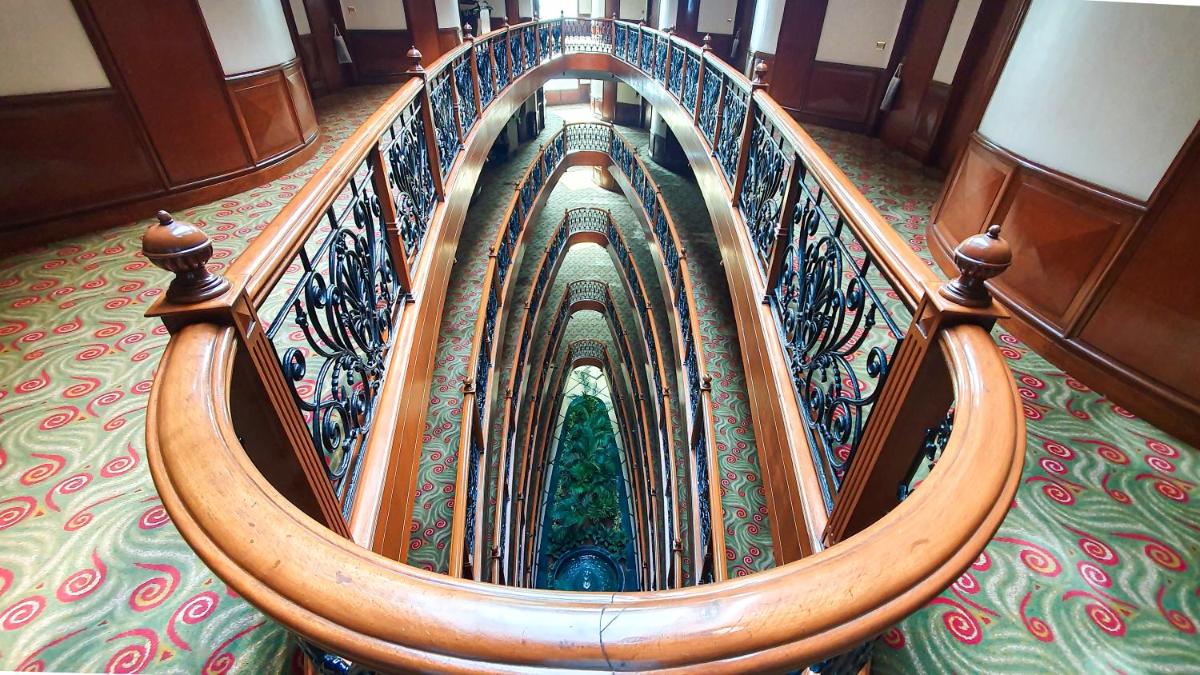 a spiral stair case in a building with at The Orchid Hotel Mumbai Vile Parle in Mumbai
