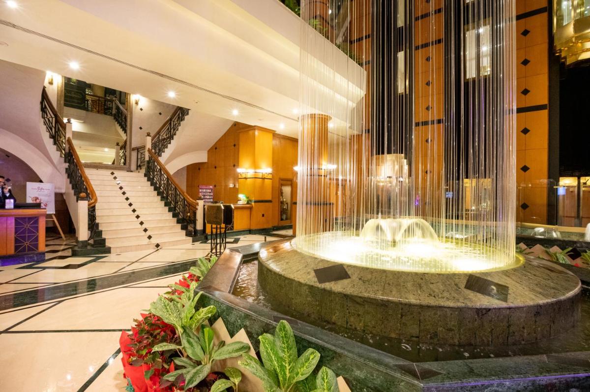 a lobby with a fountain in the middle of a building at The Orchid Hotel Mumbai Vile Parle in Mumbai