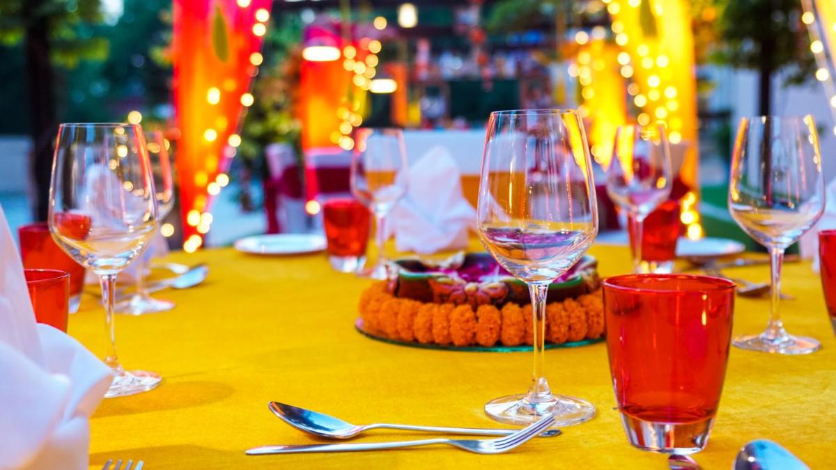a table with wine glasses on a yellow table cloth at Hyatt Place Gurgaon Udyog Vihar in Gurgaon