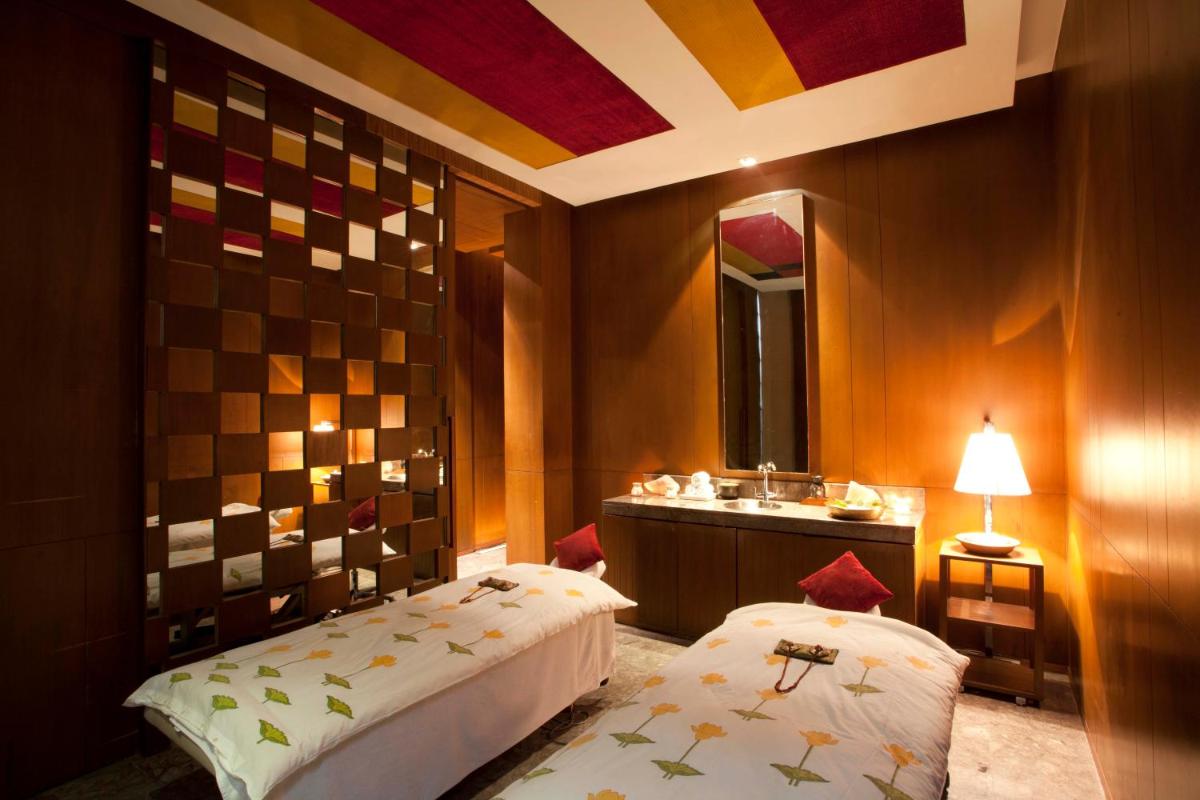 a bathroom with two beds and a sink in it at Hyatt Regency Amritsar Hotel & Spa in Amritsar
