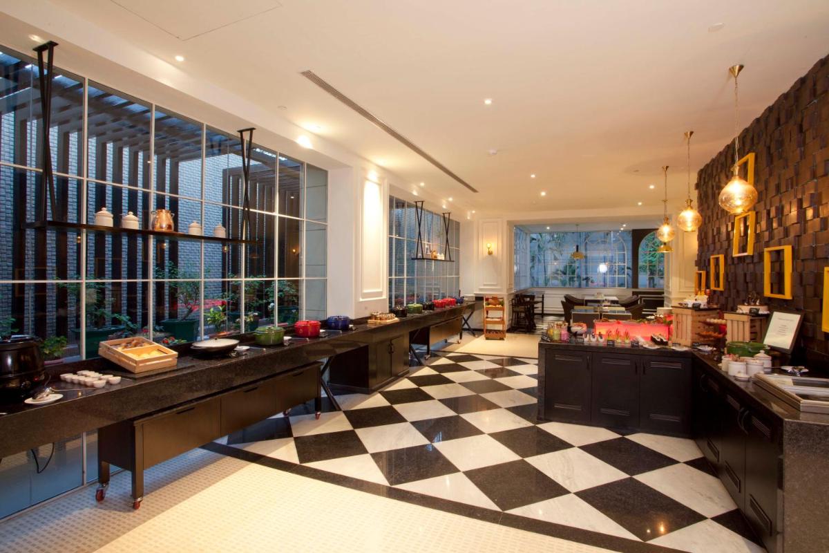 a restaurant with a checkered floor in a building at Hyatt Regency Amritsar Hotel & Spa in Amritsar