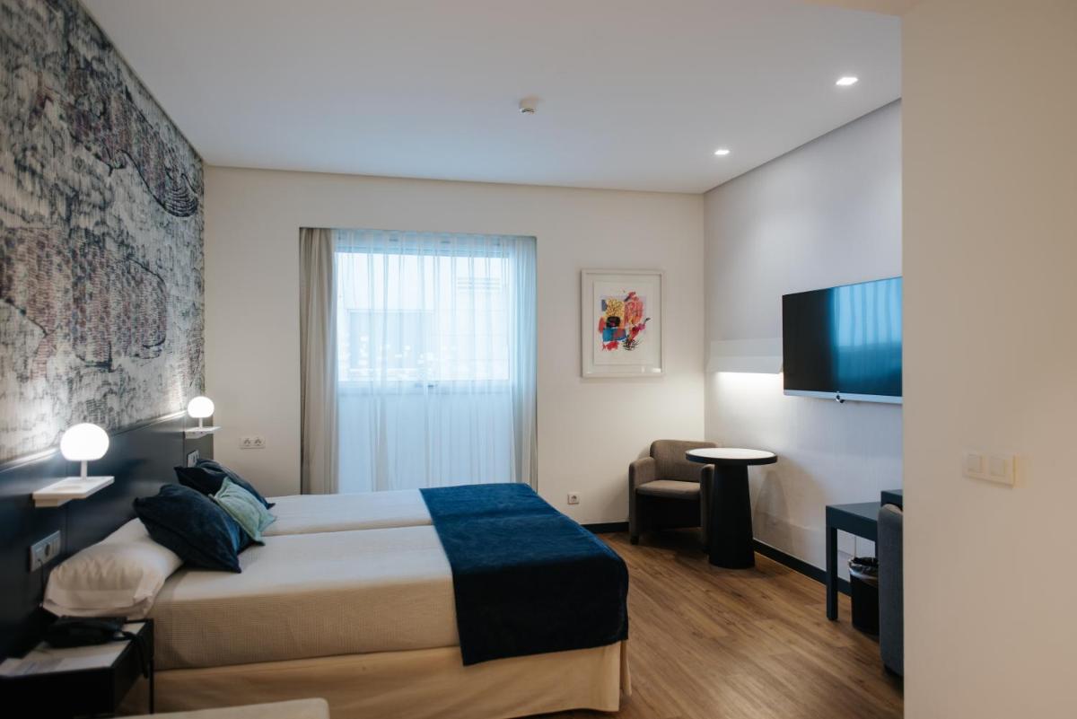 Cama o camas de una habitación en Hotel Neptuno Playa & Spa