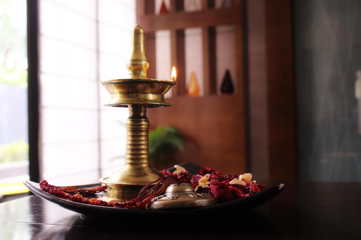 a plate with a gold candlesticks on a table at Hyatt Hyderabad Gachibowli in Hyderabad