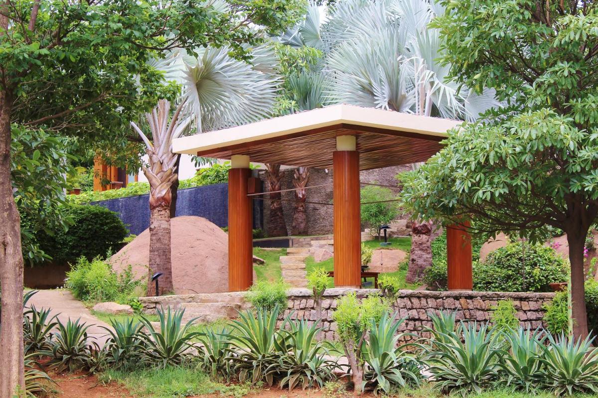 a gazebo in the middle of a garden at Hyatt Hyderabad Gachibowli in Hyderabad