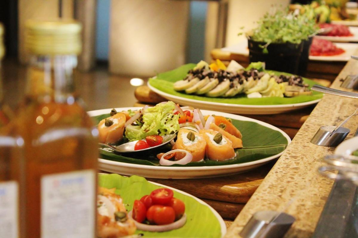 a buffet with plates of food on a table at Hyatt Hyderabad Gachibowli in Hyderabad