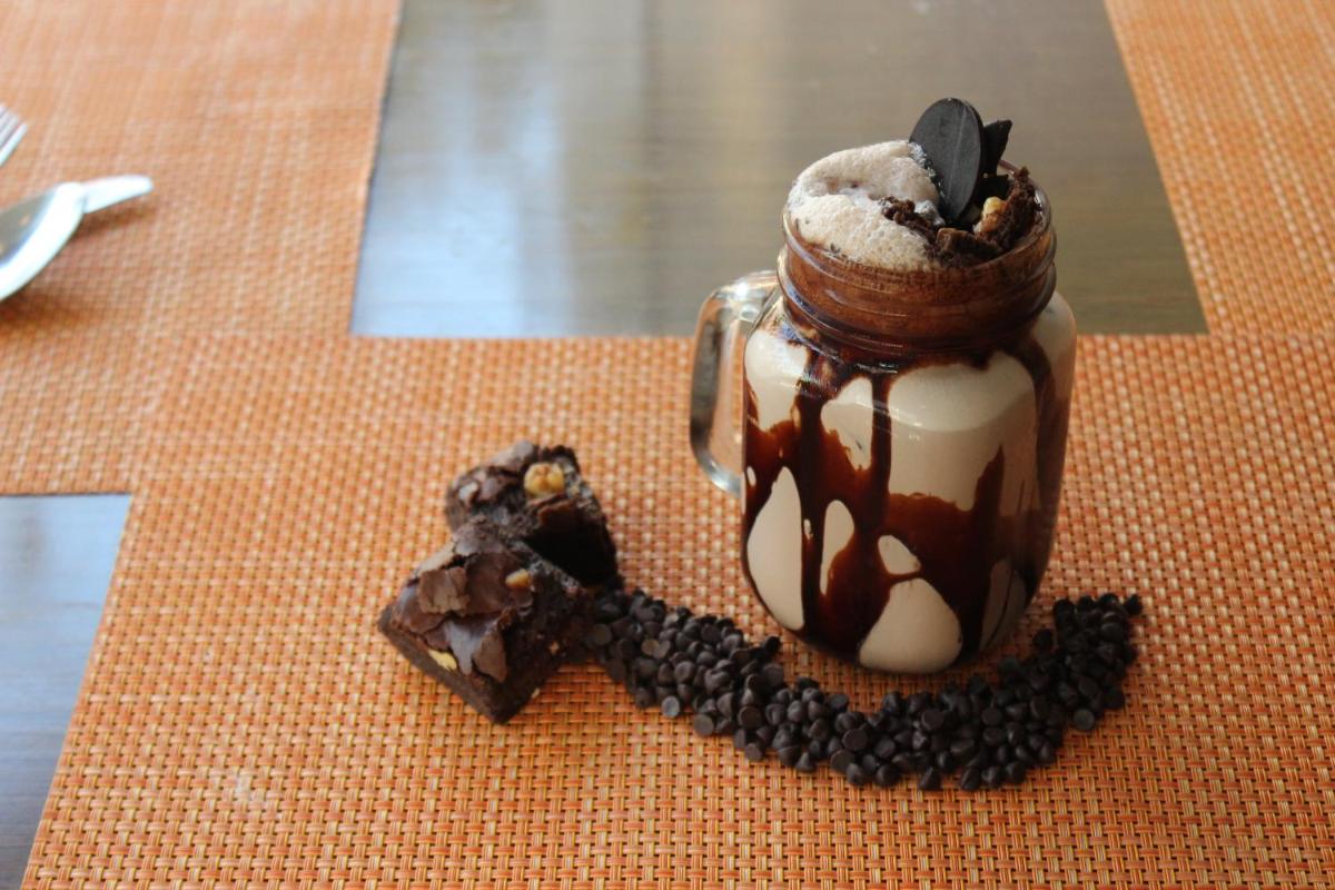 a dessert in a jar with chocolate and whipped cream at Novotel Ahmedabad in Ahmedabad