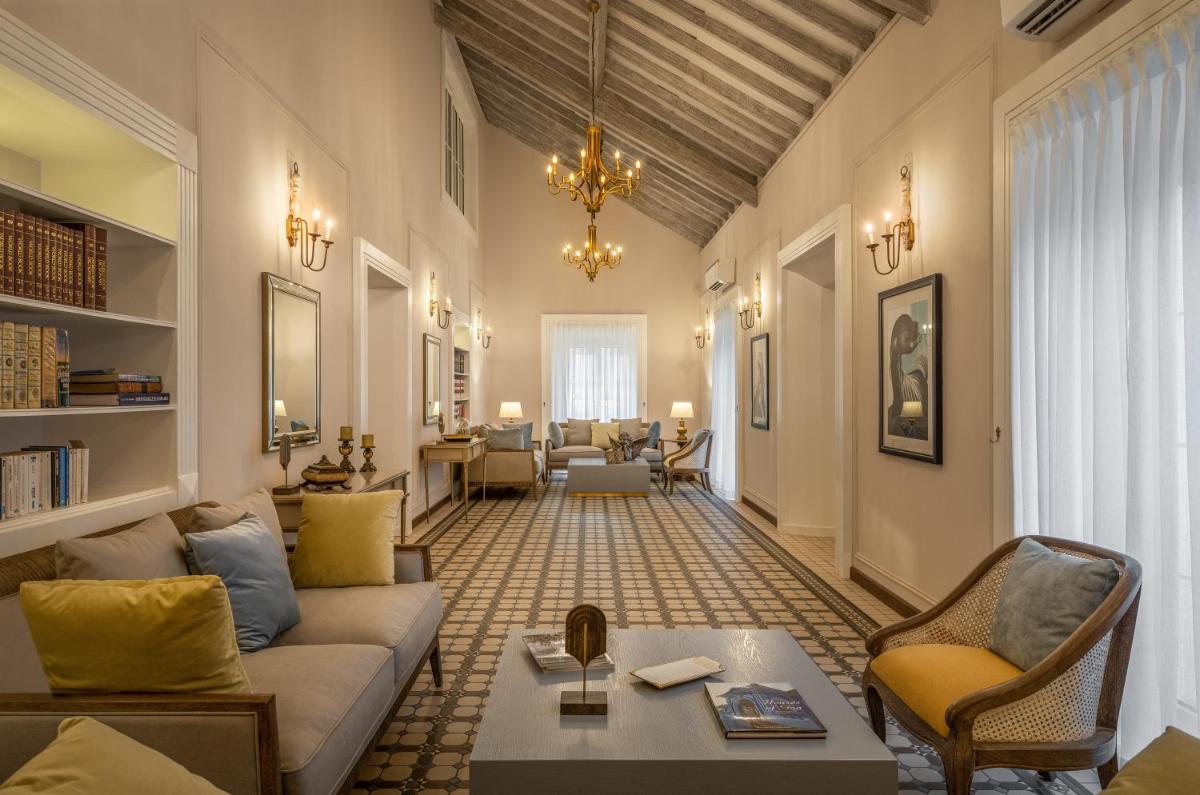a living room with a couch and a table at MansionHaus in Anjuna