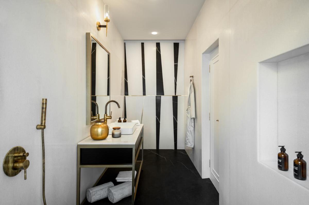 a bathroom with a sink and a mirror at MansionHaus in Anjuna