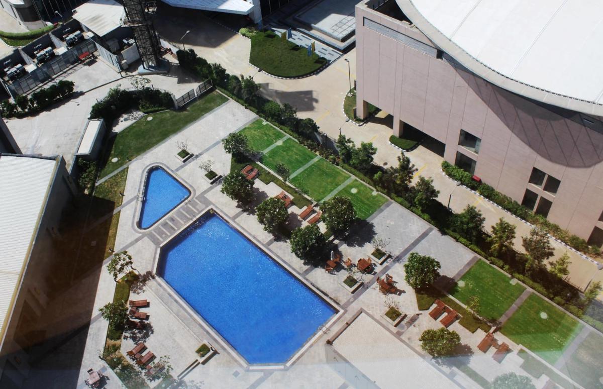 an overhead view of two large swimming pools in a building at Hyatt Regency Gurgaon in Gurgaon