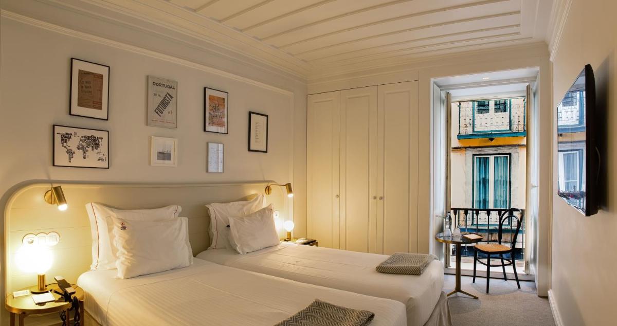 Uma cama ou camas num quarto em Lisboa Pessoa Hotel