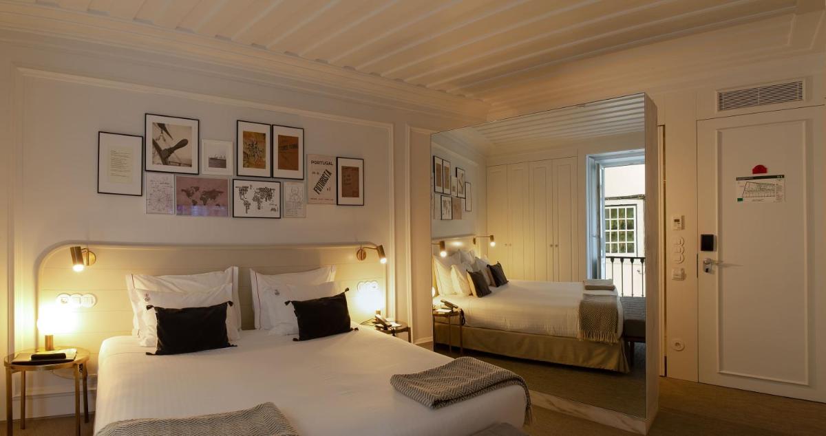 Uma cama ou camas num quarto em Lisboa Pessoa Hotel