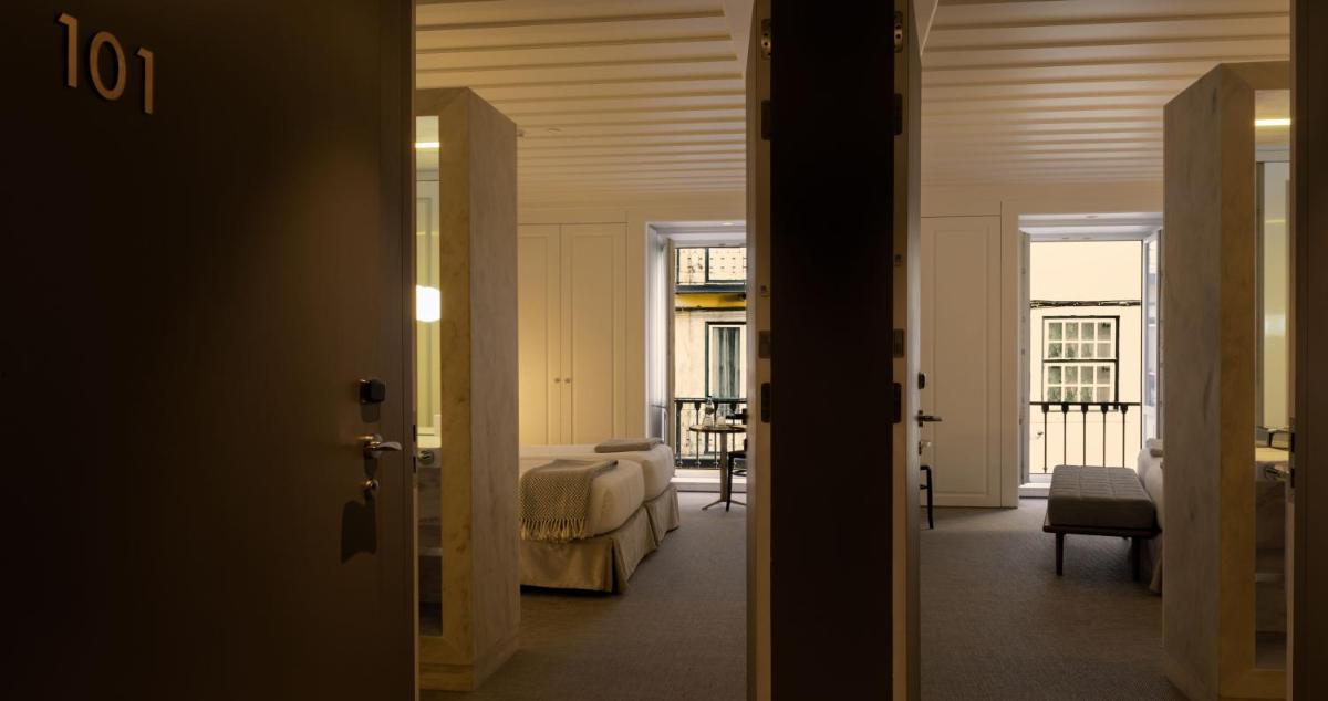 Uma cama ou camas num quarto em Lisboa Pessoa Hotel