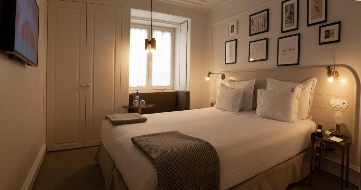 Uma cama ou camas num quarto em Lisboa Pessoa Hotel