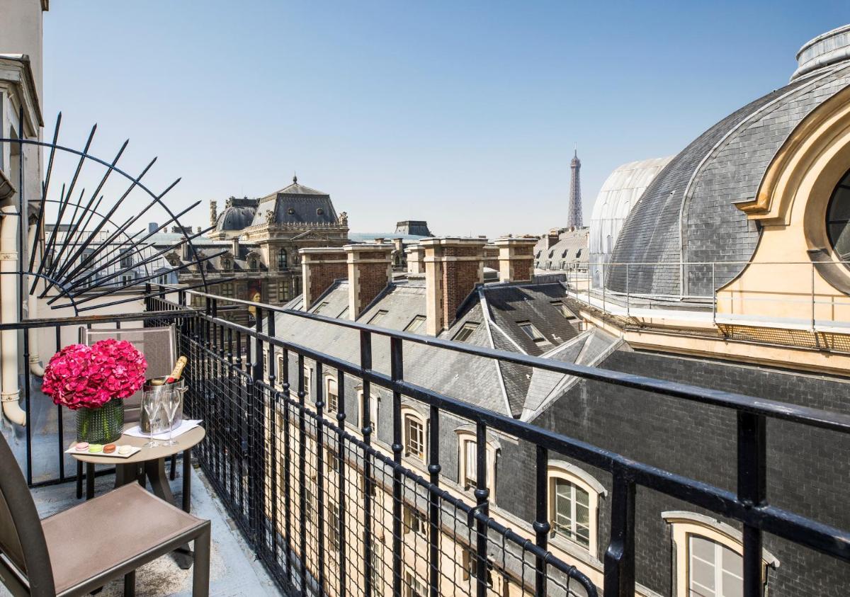 - un balcon avec un vase de fleurs sur une table dans l'établissement Grand Hôtel Du Palais Royal, à Paris