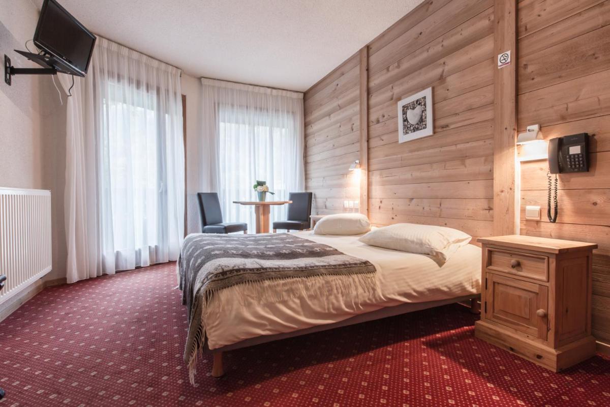 Un ou plusieurs lits dans un hébergement de l'établissement Hotel Club Le Crêt