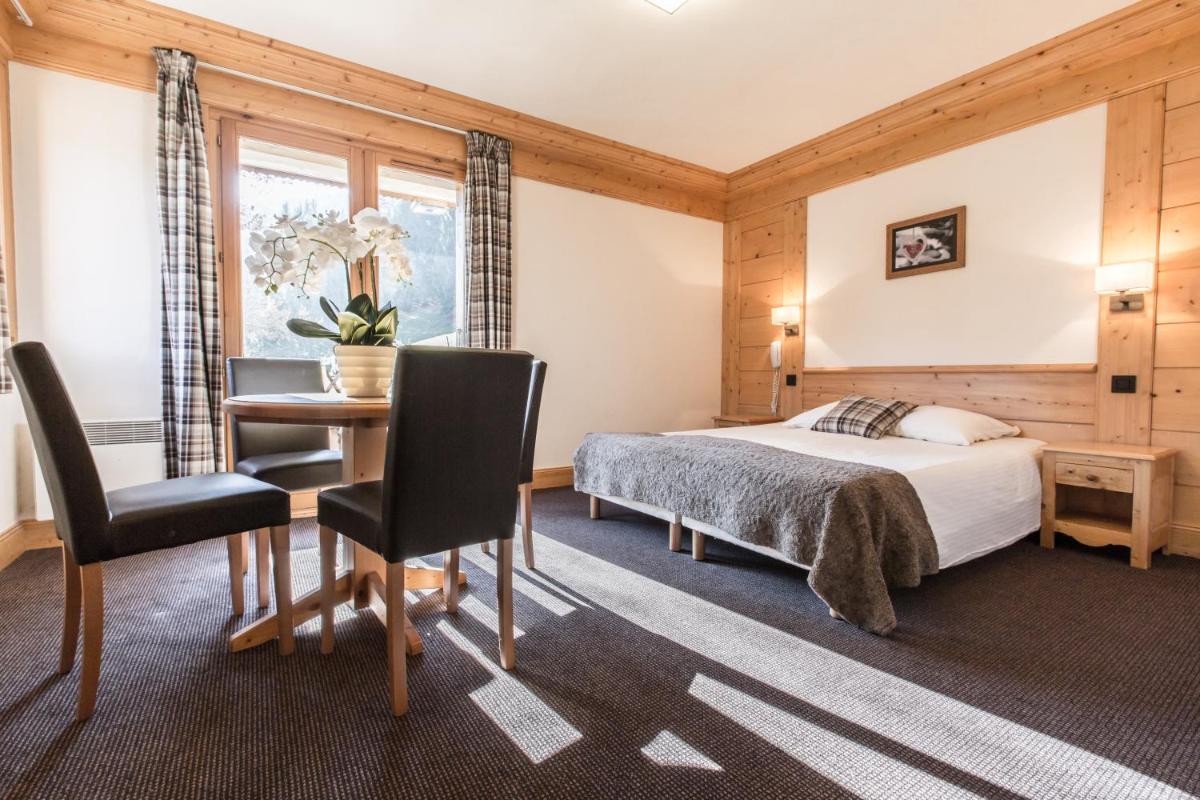 Un ou plusieurs lits dans un hébergement de l'établissement Hotel Club Le Crêt