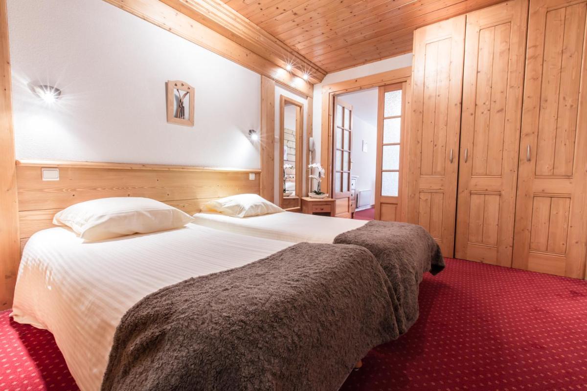Un ou plusieurs lits dans un hébergement de l'établissement Hotel Club Le Crêt