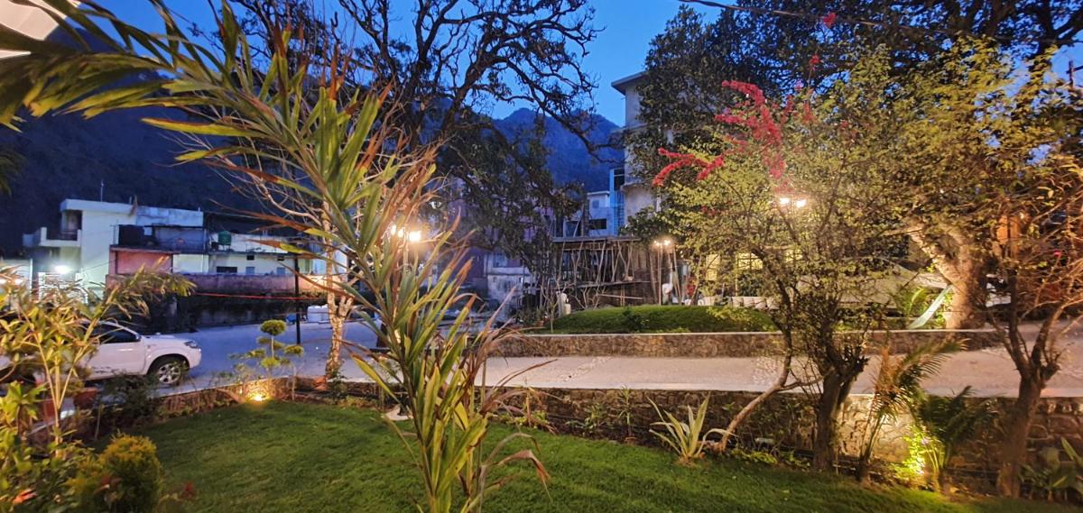 a view of a yard at night with lights at Antalya By Divine Ganga Cottage in Rishīkesh