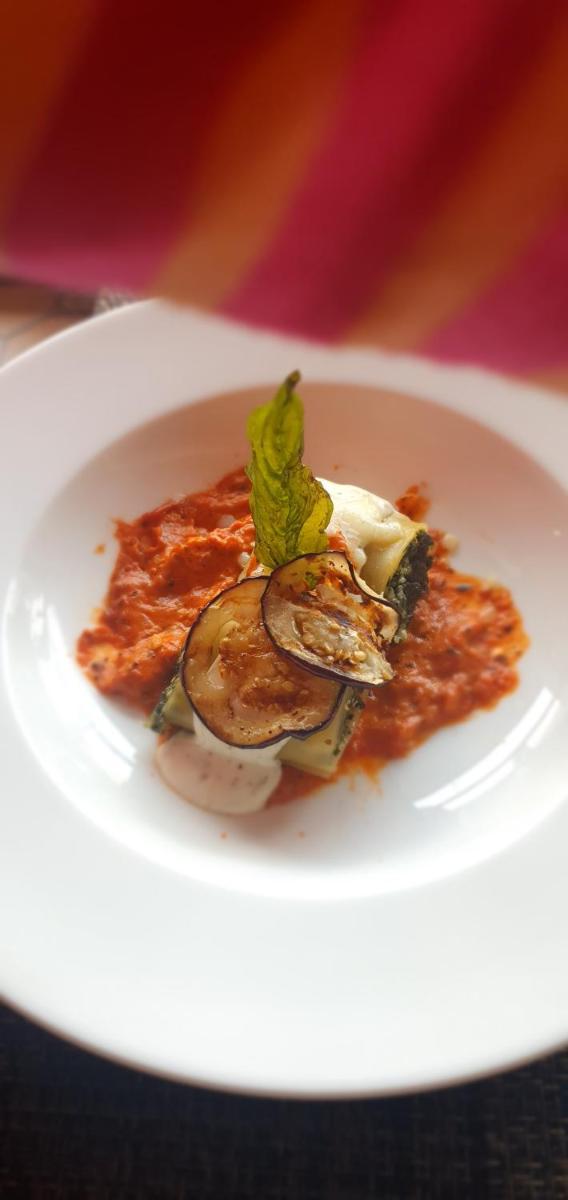a plate of food on a white plate at Antalya By Divine Ganga Cottage in Rishīkesh