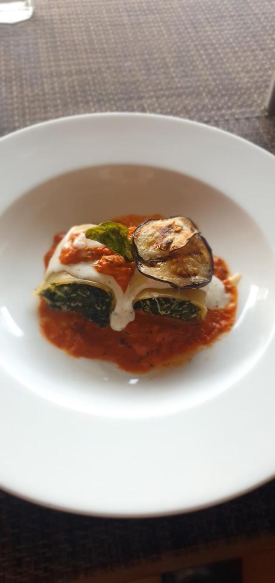 a white plate with some food on a table at Antalya By Divine Ganga Cottage in Rishīkesh