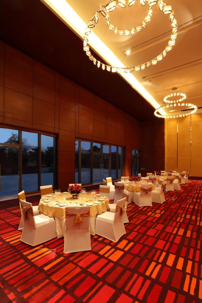 a banquet hall with white tables and white chairs at Hyatt Regency Chandigarh in Chandīgarh