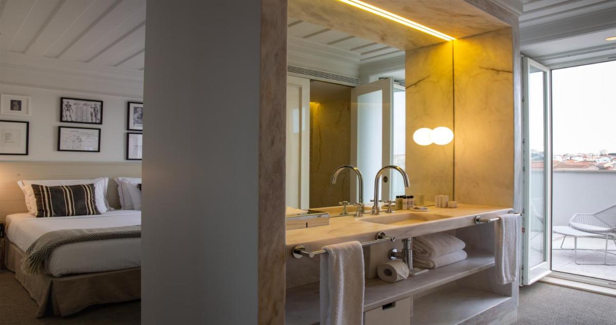 Uma cama ou camas num quarto em Lisboa Pessoa Hotel