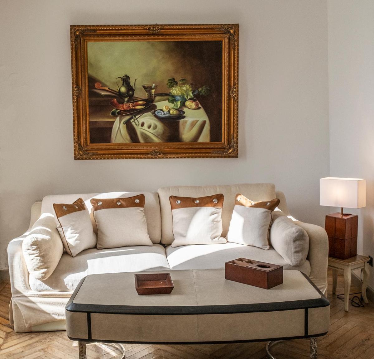 un salon avec un canapé et un tableau au mur dans l'établissement Château de Tressé, à Pouancé un salon avec un canapé et un tableau au mur dans l'établissement Château de Tressé, à Pouancé