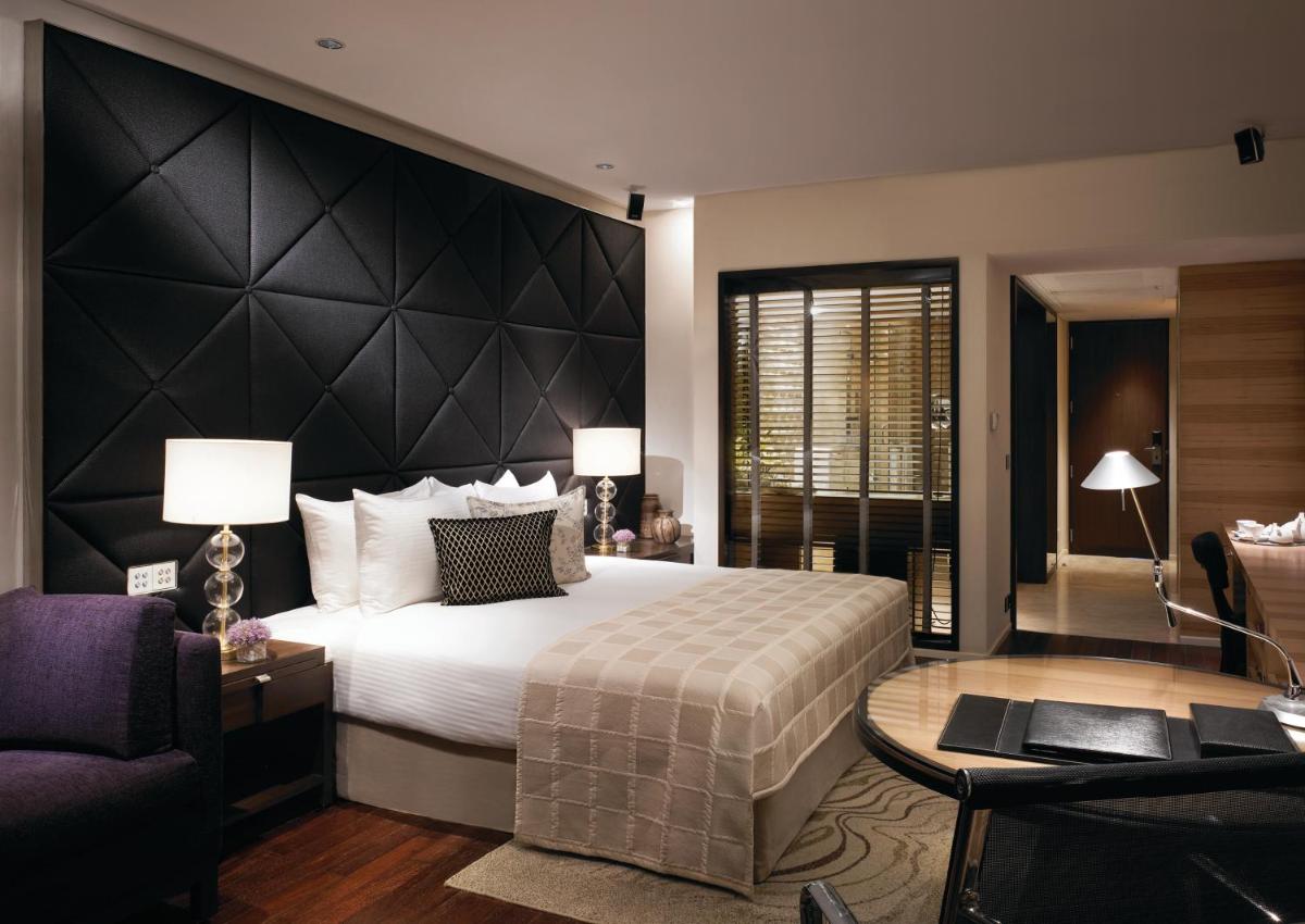 a bedroom with a large bed with a black headboard at Taj Lands End in Mumbai a bedroom with a large bed with a black headboard at Taj Lands End in Mumbai