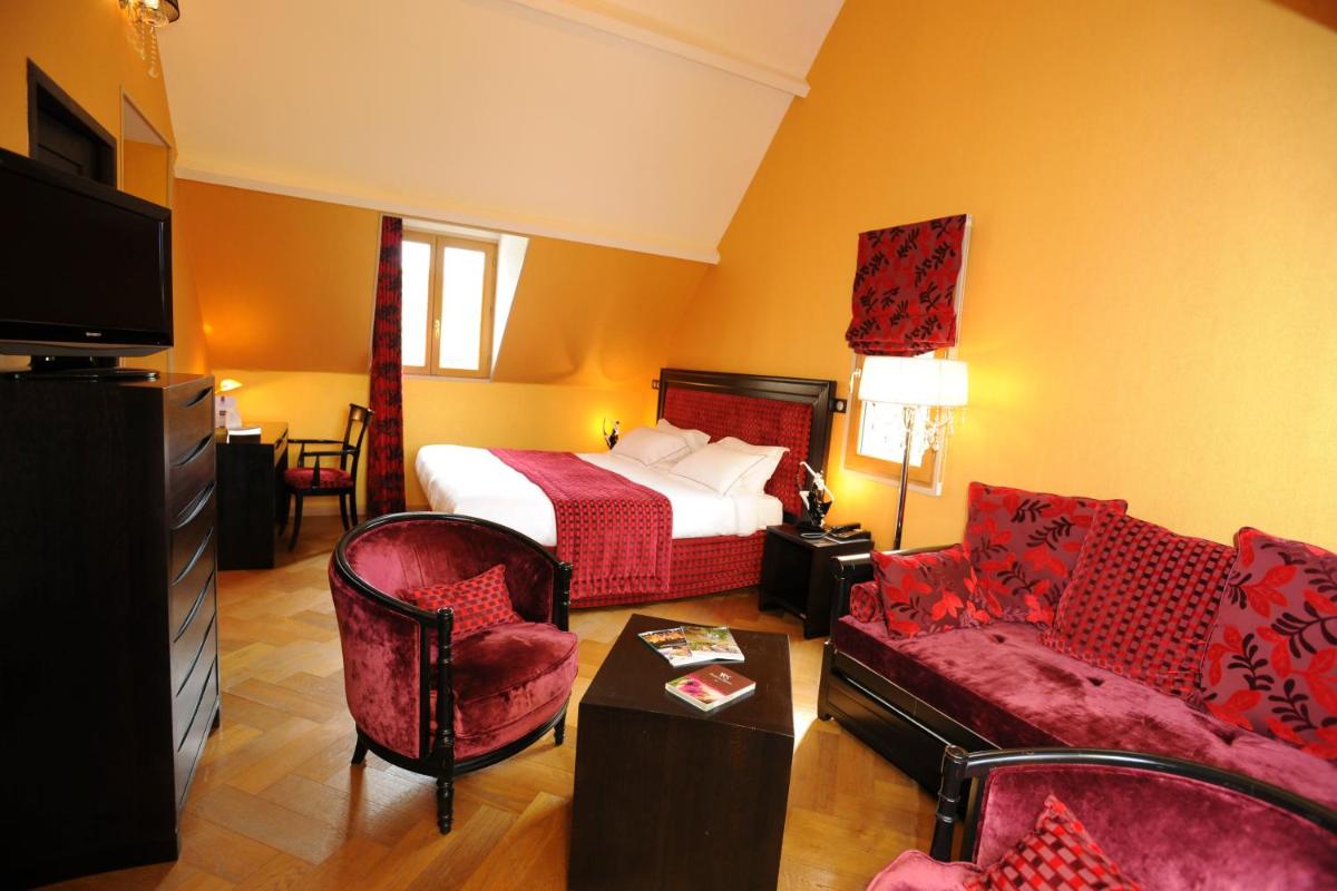Un ou plusieurs lits dans un hébergement de l'établissement Demeures & Châteaux Hôtel Domaine le Clos des Fontaines