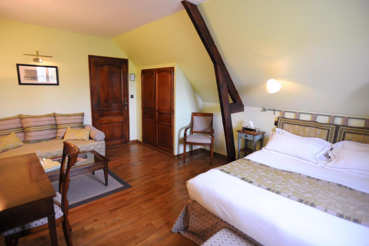 Un ou plusieurs lits dans un hébergement de l'établissement Demeures & Châteaux Hôtel Domaine le Clos des Fontaines