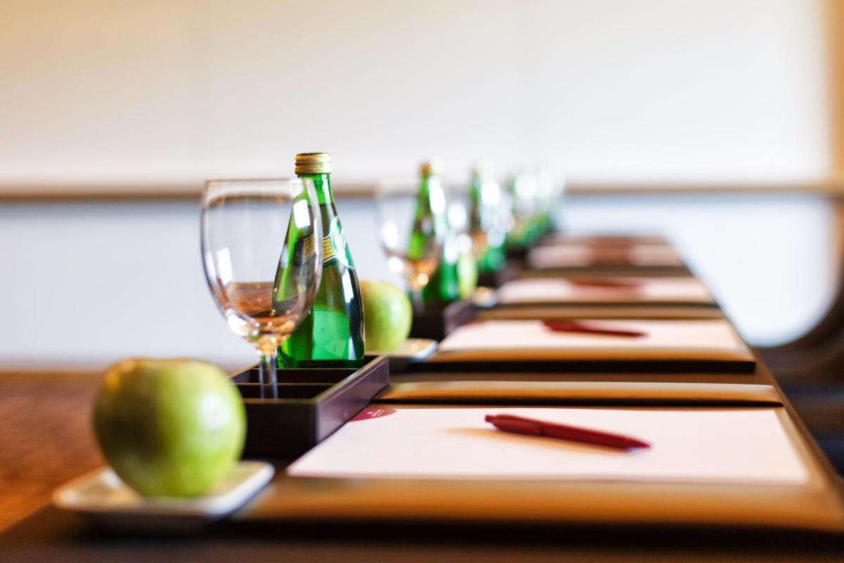 a row of bottles of wine and apples on a table at Crowne Plaza Ahmedabad City Centre by IHG in Ahmedabad