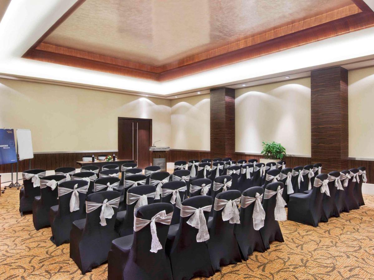 a banquet hall with rows of chairs in a room at Novotel Mumbai Juhu Beach in Mumbai