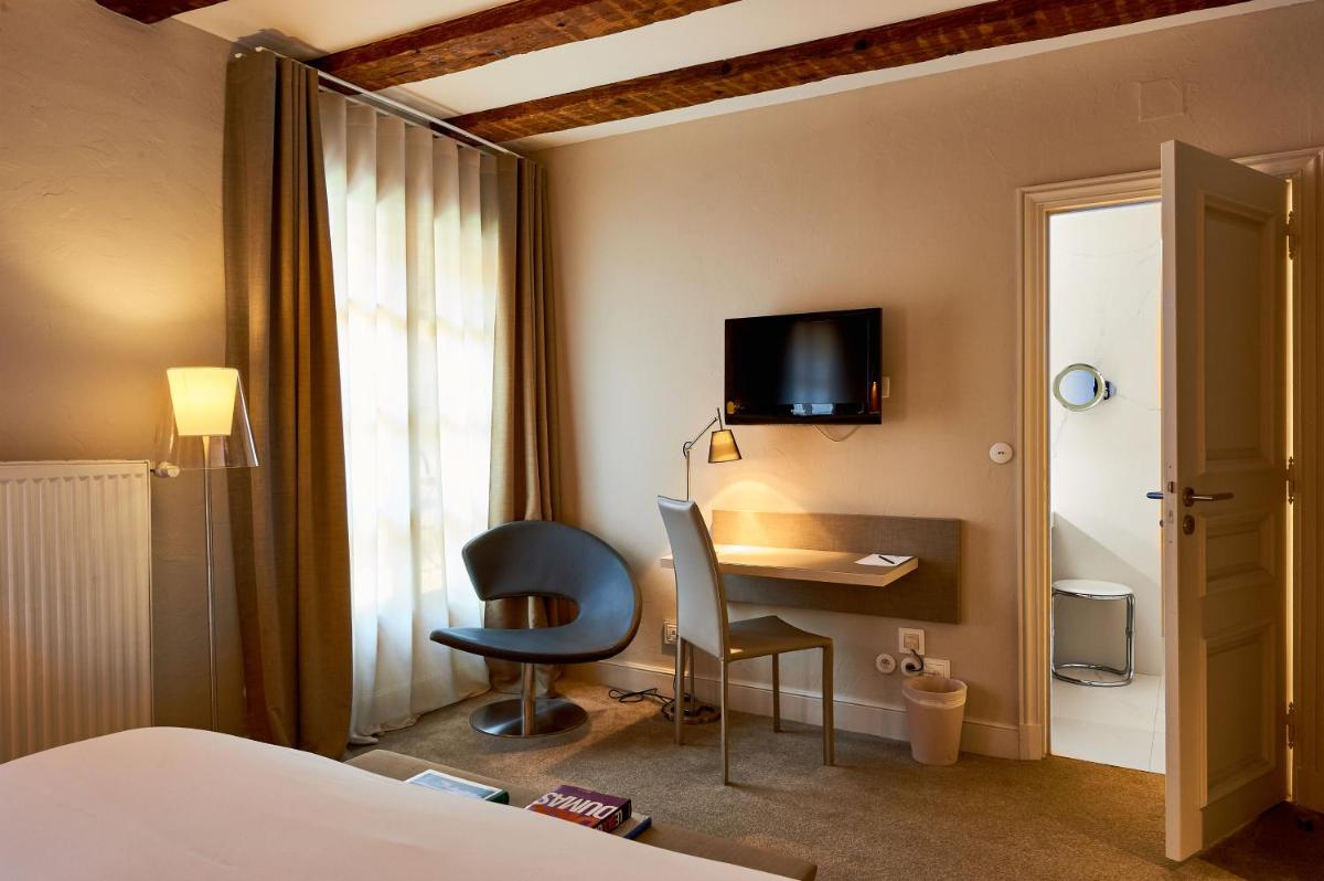 Télévision ou salle de divertissement dans l'établissement Relais & Châteaux La Maison Des Têtes