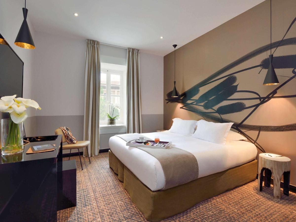 Un ou plusieurs lits dans un hébergement de l'établissement Jules César Hotel & Spa Arles - MGallery Collection