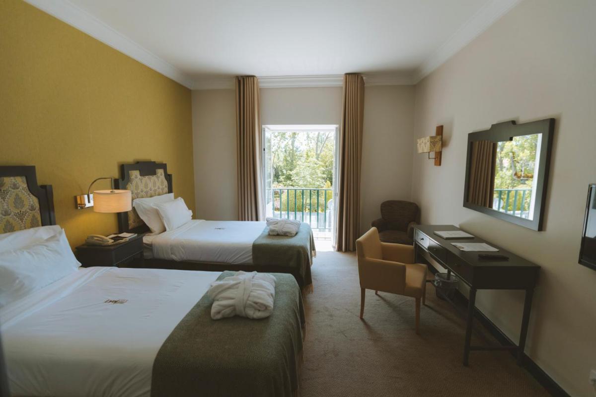 Uma cama ou camas num quarto em Conimbriga Hotel do Paço