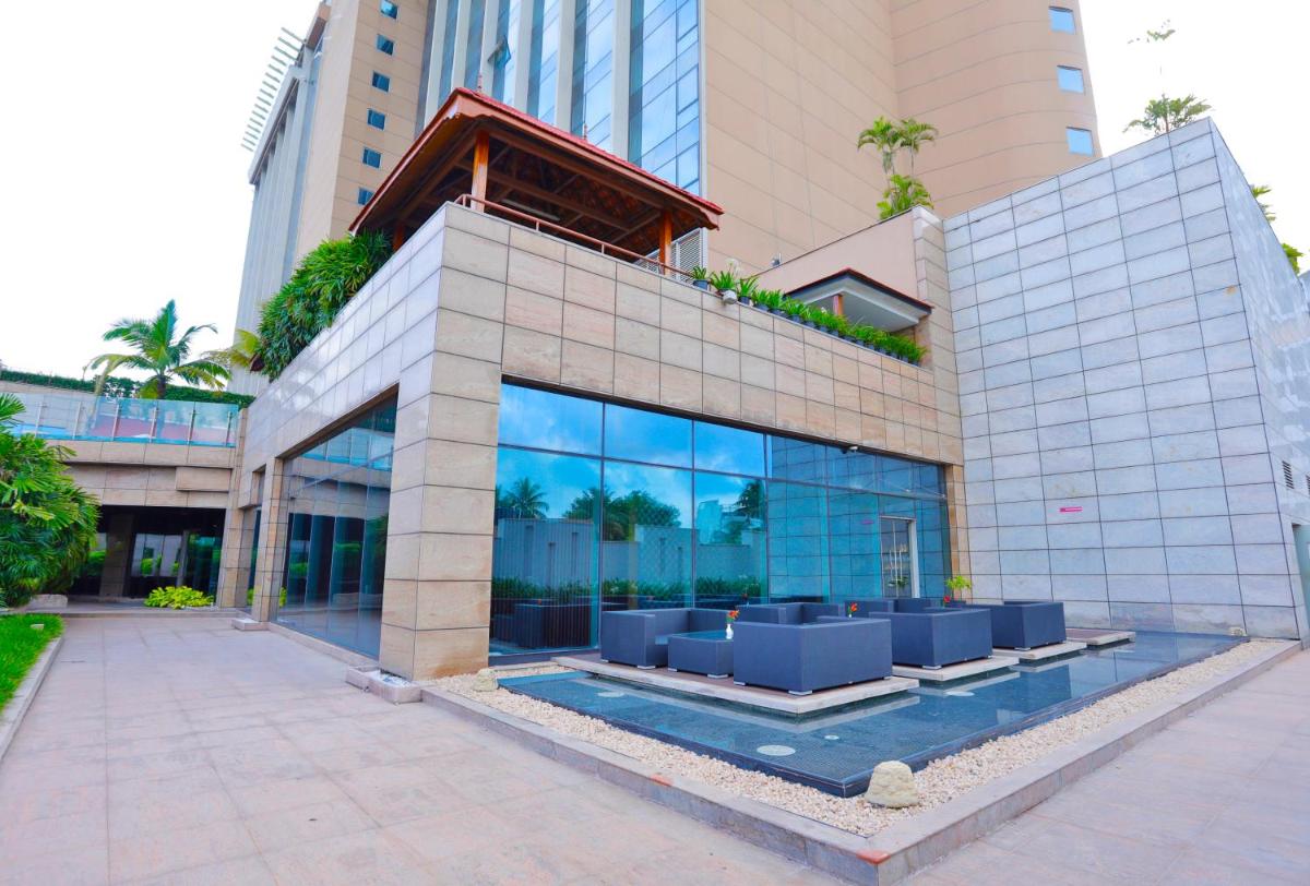 a building with a pool in front of it at Crowne Plaza Kochi by IHG in Cochin