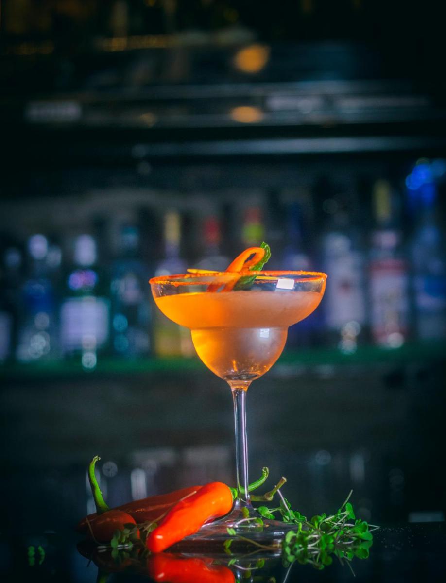 a drink in a martini glass sitting on a bar at Holiday Inn Jaipur City Centre by IHG in Jaipur a drink in a martini glass sitting on a bar at Holiday Inn Jaipur City Centre by IHG in Jaipur