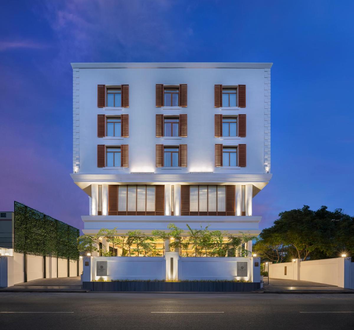 a large white building with aventh floor at The Residency Towers Puducherry in Puducherry