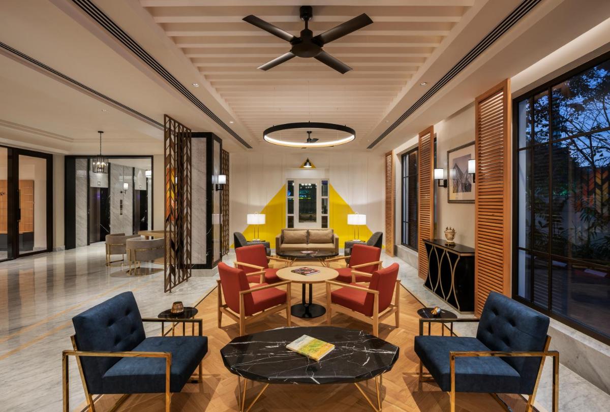 a living room with furniture and a ceiling fan at The Residency Towers Puducherry in Puducherry