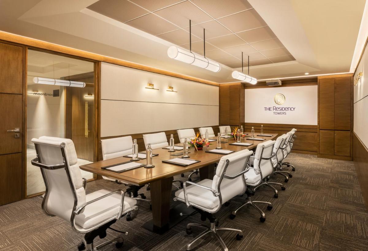 a conference room with a long table and chairs at The Residency Towers Puducherry in Puducherry +59 photos