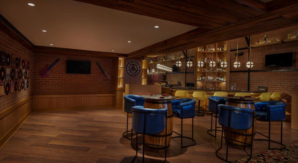 a bar with blue stools in a restaurant at The Residency Towers Puducherry in Puducherry