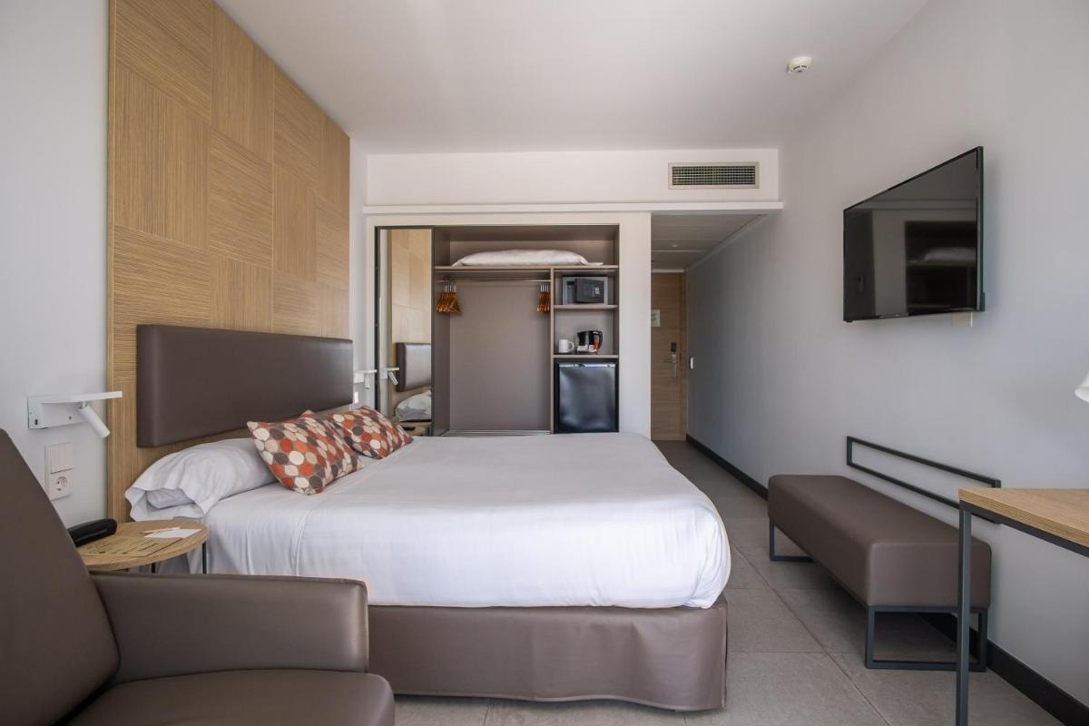 Cama o camas de una habitación en Hotel Cap Negret